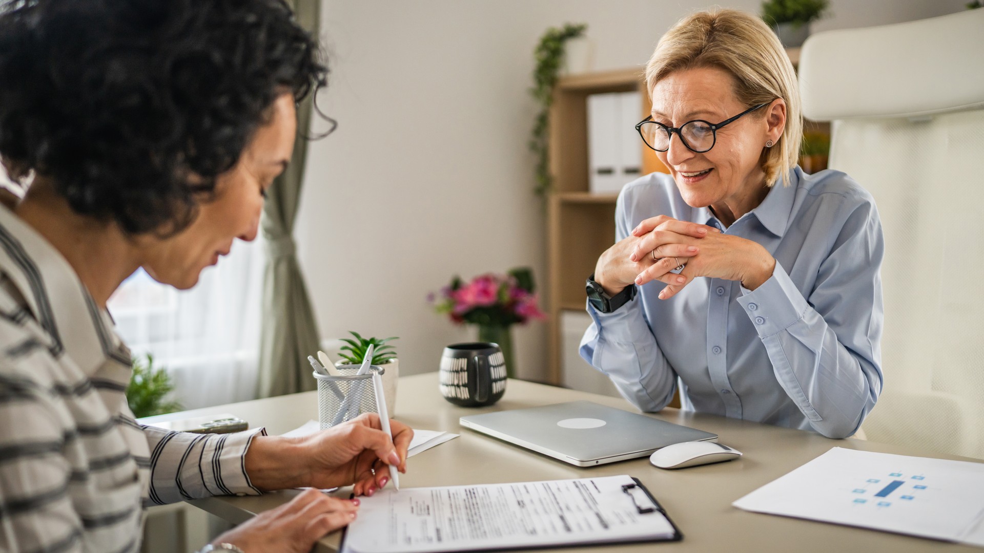 Two mature woman signature document, contract at work at office